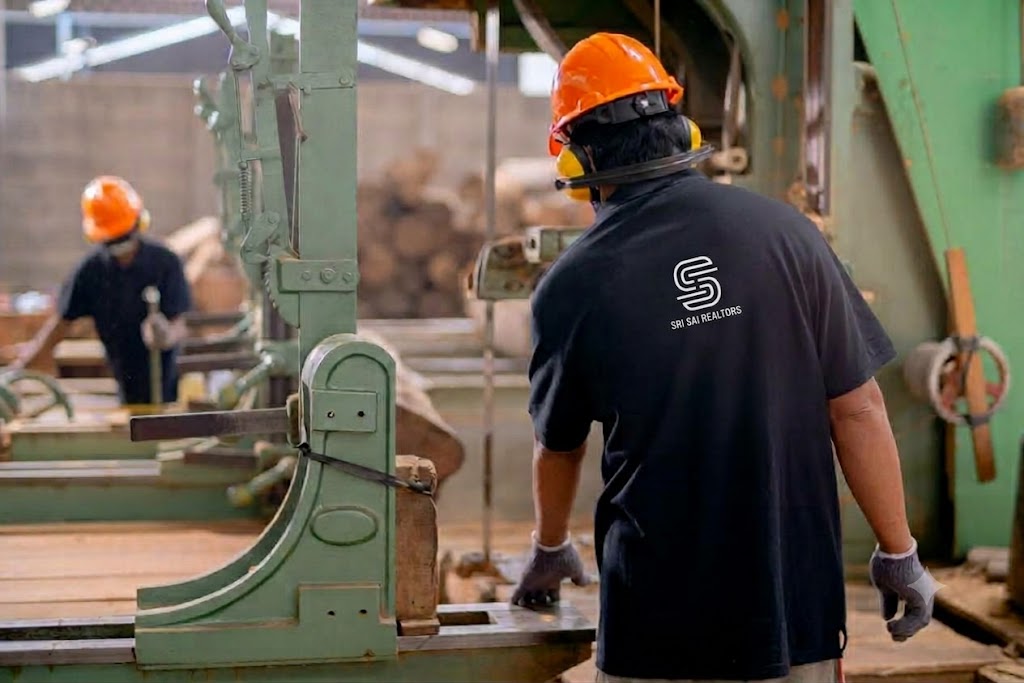 Workers operating machinery in a furniture manufacturing facility